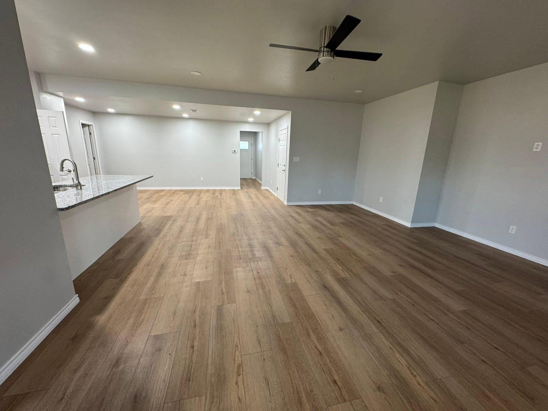 Open-plan kitchen and living area with wood flooring