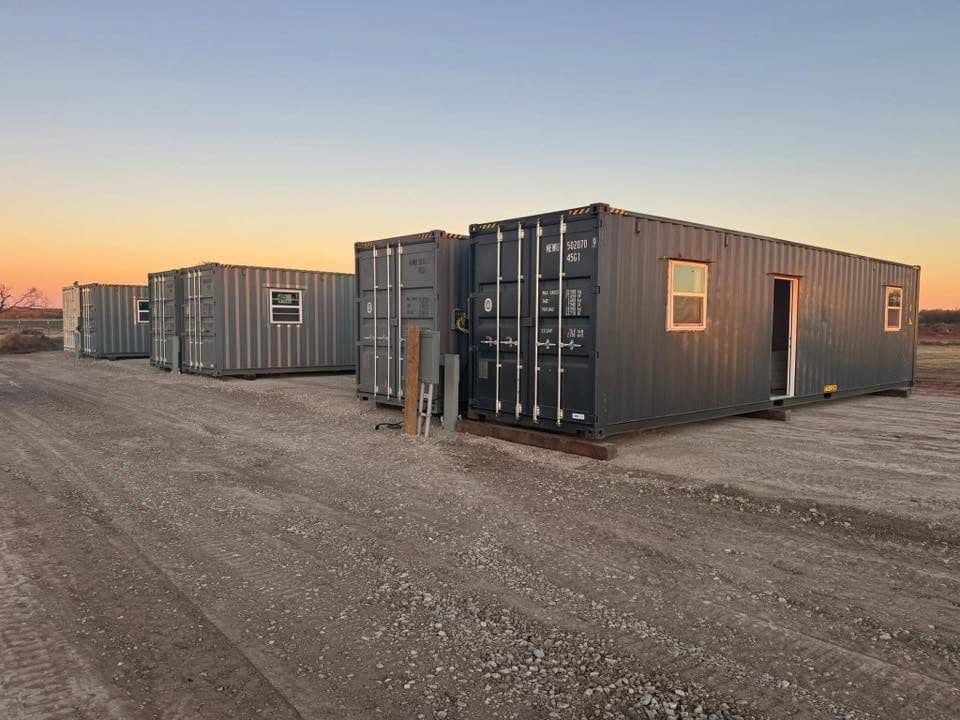 A row of container housing units at dusk